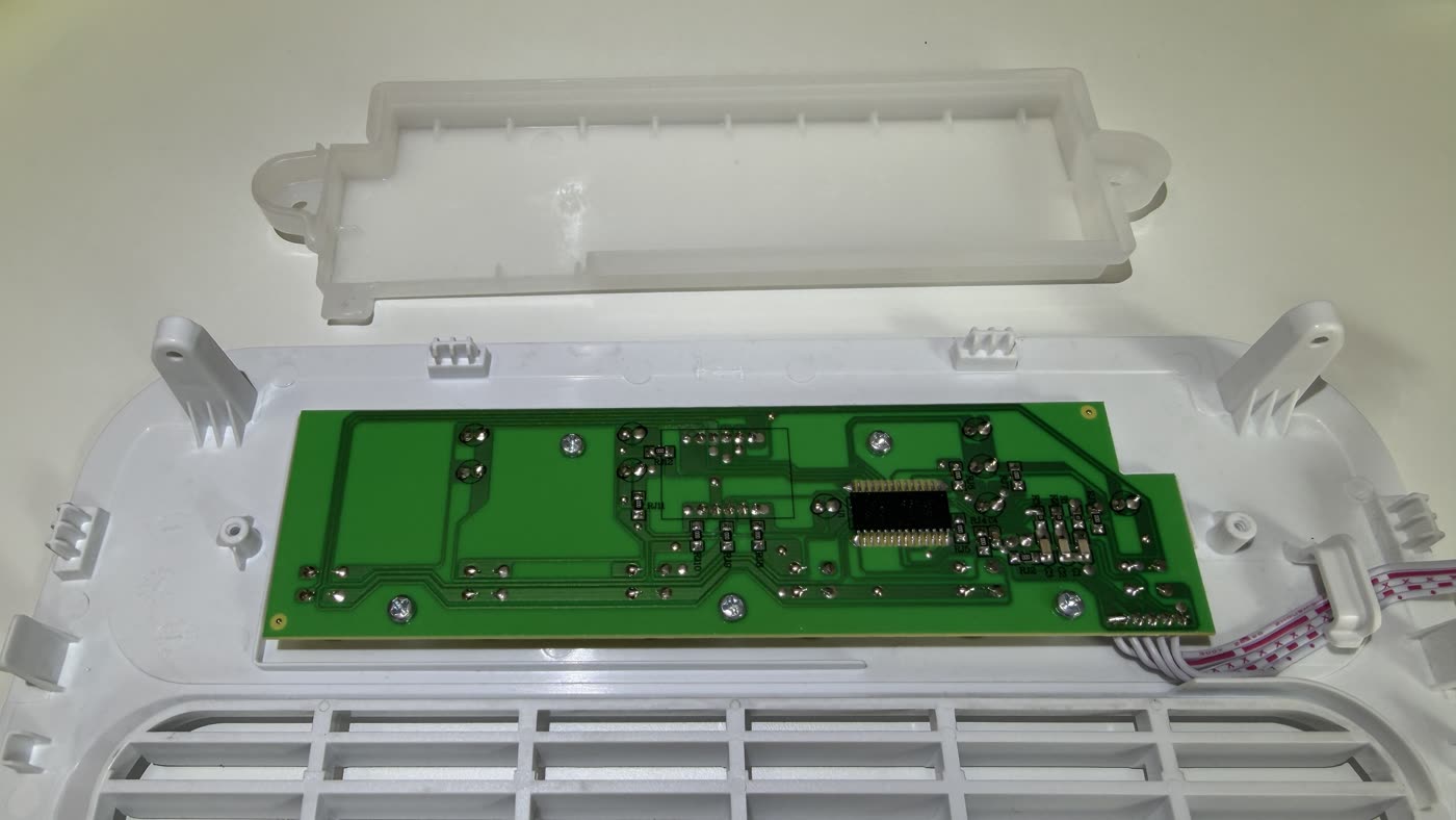 Control unit of an identical appliance: a small circuit board embedded directly in white plastic.